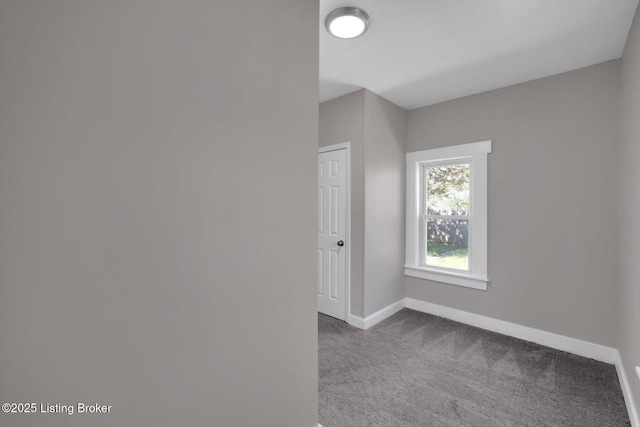 611 E Hill St, Louisville, KY 40217 - spare room with baseboards and carpet flooring