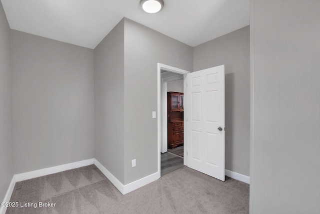 611 E Hill St, Louisville, KY 40217 - additional living space with carpet flooring and baseboards