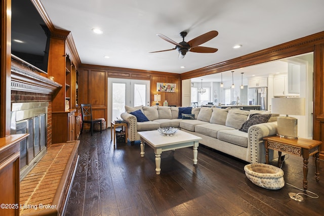 700 Sentry Way, Louisville, KY 40223 - living area featuring ornamental molding, a ceiling fan, healthy amount of natural light, a fireplace, and dark wood-type flooring