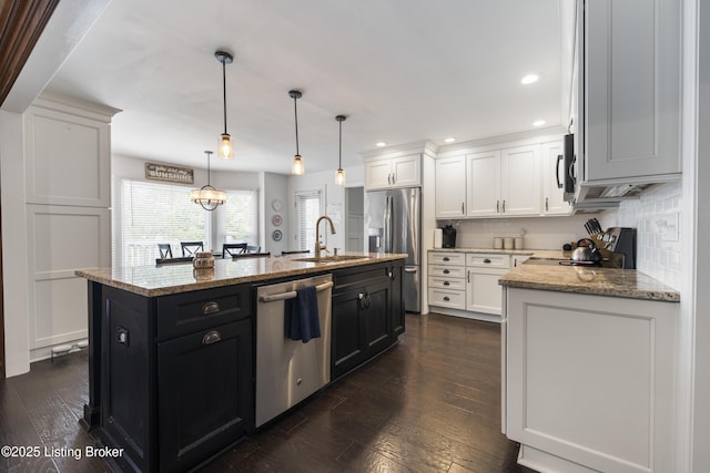 700 Sentry Way, Louisville, KY 40223 - kitchen with appliances with stainless steel finishes, a sink, white cabinetry, a center island with sink, and tasteful backsplash