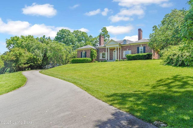 1802 Park Boundary Rd, Louisville, KY 40205 - neoclassical home featuring a front lawn, brick siding, and a chimney