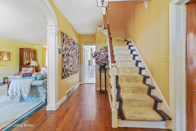 1802 Park Boundary Rd, Louisville, KY 40205 - staircase with arched walkways, decorative columns, wood finished floors, and baseboards