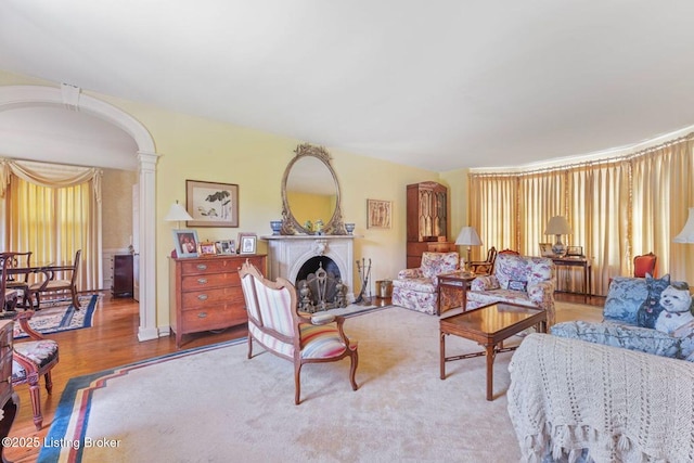 1802 Park Boundary Rd, Louisville, KY 40205 - living area featuring wood finished floors, ornate columns, and a fireplace with raised hearth