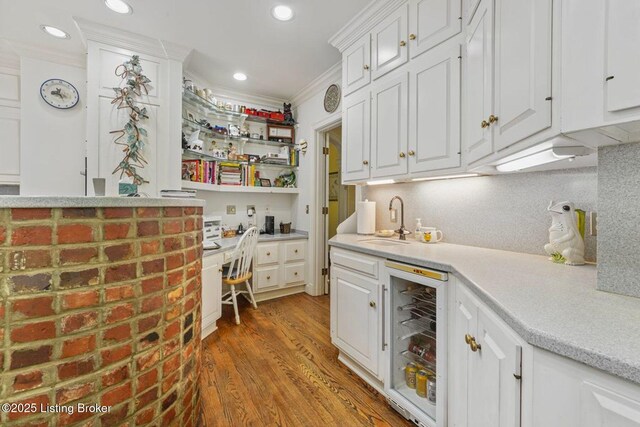 1802 Park Boundary Rd, Louisville, KY 40205 - indoor bar featuring wood finished floors, beverage cooler, ornamental molding, recessed lighting, and built in desk