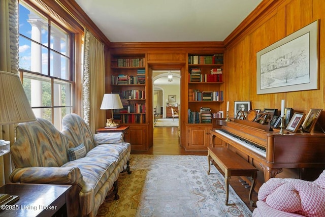 1802 Park Boundary Rd, Louisville, KY 40205 - sitting room with wooden walls, ornamental molding, arched walkways, built in features, and wood finished floors