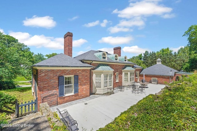 1802 Park Boundary Rd, Louisville, KY 40205 - back of house featuring brick siding, a chimney, and a patio area