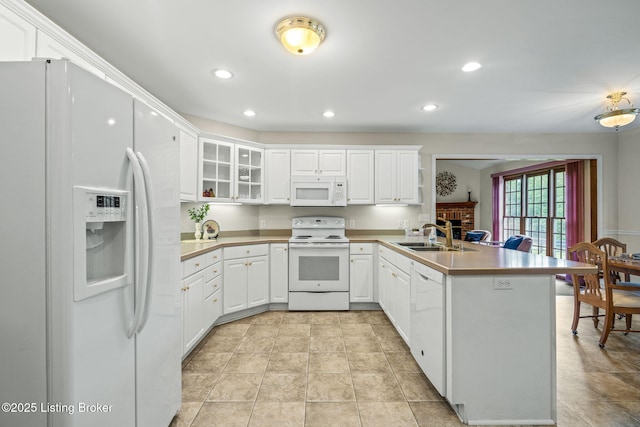 2434 Eastwood Cir, Crestwood, KY 40014 - kitchen featuring white appliances, a sink, a peninsula, a brick fireplace, and recessed lighting