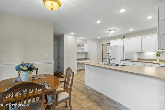 2434 Eastwood Cir, Crestwood, KY 40014 - kitchen with a sink, white fridge with ice dispenser, a peninsula, white cabinetry, and recessed lighting