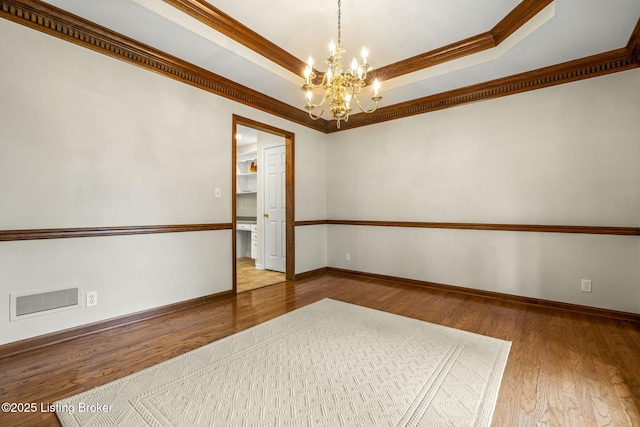 2434 Eastwood Cir, Crestwood, KY 40014 - empty room featuring a chandelier, crown molding, wood finished floors, baseboards, and a tray ceiling