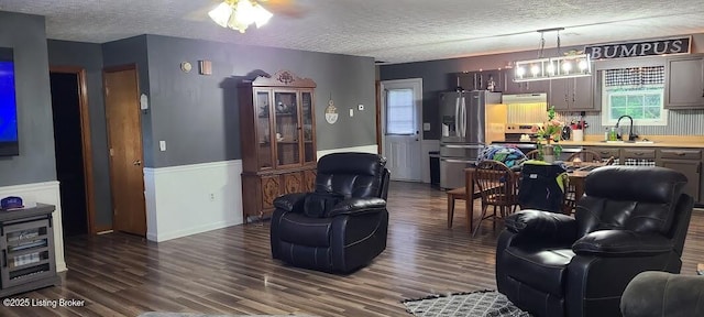 7 Dylan Ln, Upton, KY 42784 - living room featuring a textured ceiling, dark wood-style floors, and a wainscoted wall