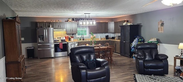 7 Dylan Ln, Upton, KY 42784 - kitchen featuring stainless steel appliances, a sink, light countertops, dark wood-style floors, and under cabinet range hood