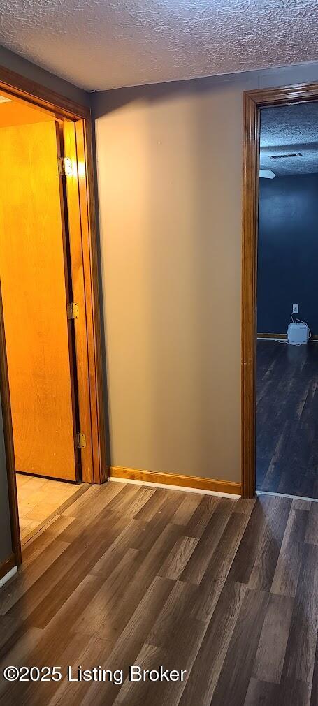 7 Dylan Ln, Upton, KY 42784 - corridor with a textured ceiling, wood finished floors, and baseboards