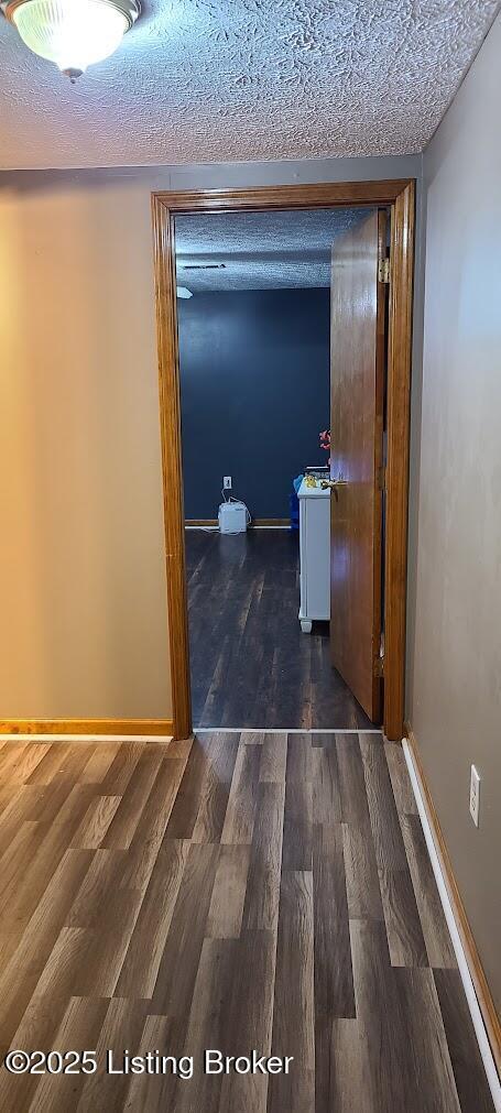 7 Dylan Ln, Upton, KY 42784 - hallway with dark wood-style flooring, baseboards, and a textured ceiling