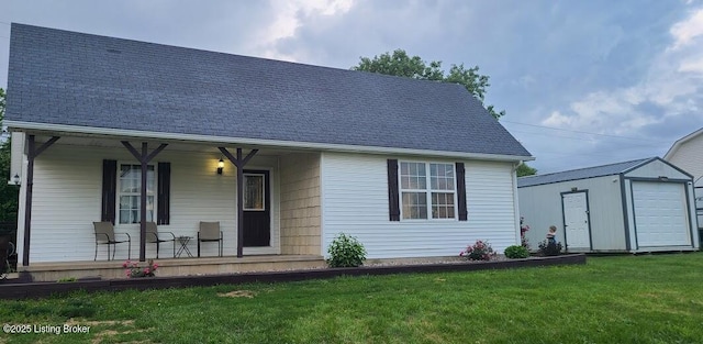 7 Dylan Ln, Upton, KY 42784 - view of front facade featuring covered porch, a front lawn, an outdoor structure, a garage, and roof with shingles