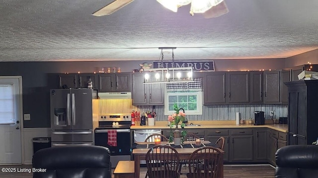 7 Dylan Ln, Upton, KY 42784 - kitchen with stainless steel appliances, under cabinet range hood, a sink, light countertops, and a textured ceiling
