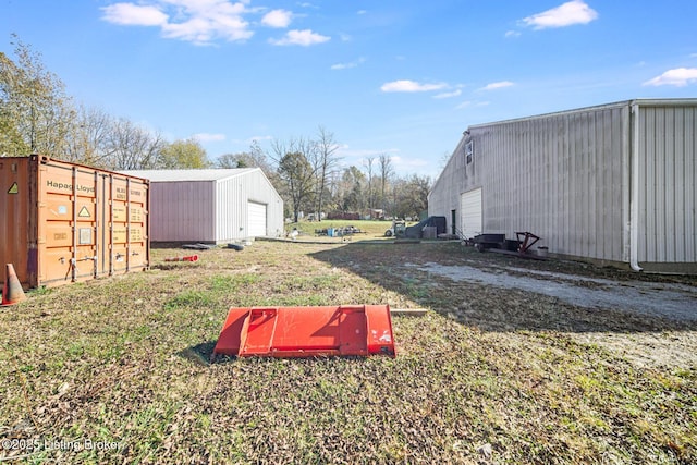 264A Saint Catherine St, New Haven, KY 40051 - view of yard featuring a detached garage and an outbuilding