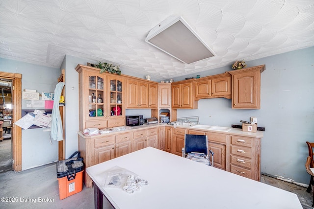 264A Saint Catherine St, New Haven, KY 40051 - kitchen featuring light countertops, glass insert cabinets, black microwave, and unfinished concrete flooring