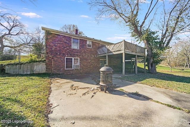 264A Saint Catherine St, New Haven, KY 40051 - back of property featuring brick siding, a yard, a chimney, and a patio