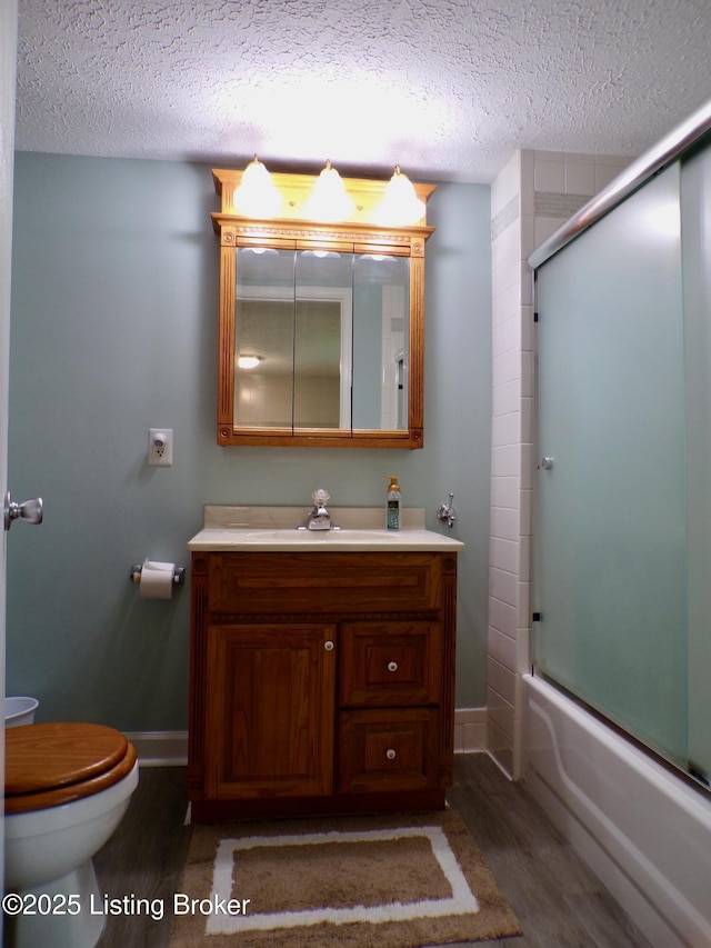 791 W Blue Lick Rd, Shepherdsville, KY 40165 - full bath with wood finished floors, toilet, a textured ceiling, vanity, and baseboards
