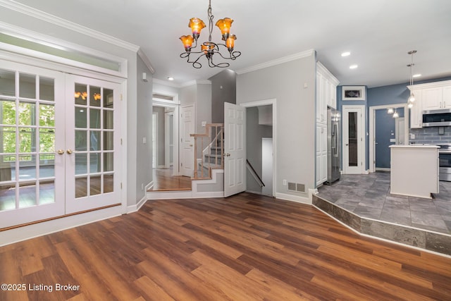 2516 Phoenix Hill Dr, Louisville, KY 40207 - kitchen featuring stainless steel appliances, baseboards, dark wood-style floors, a chandelier, and white cabinetry