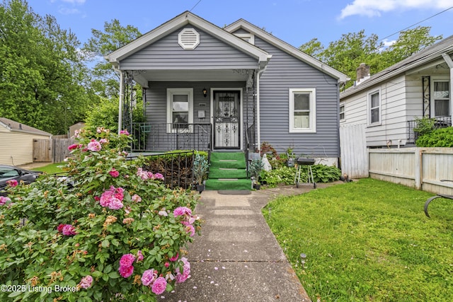 1412 Haskin Ave, Louisville, KY 40215 - shotgun-style home with covered porch and a gate