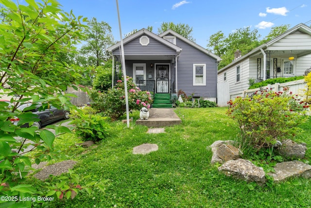 1412 Haskin Ave, Louisville, KY 40215 - shotgun-style home featuring a porch