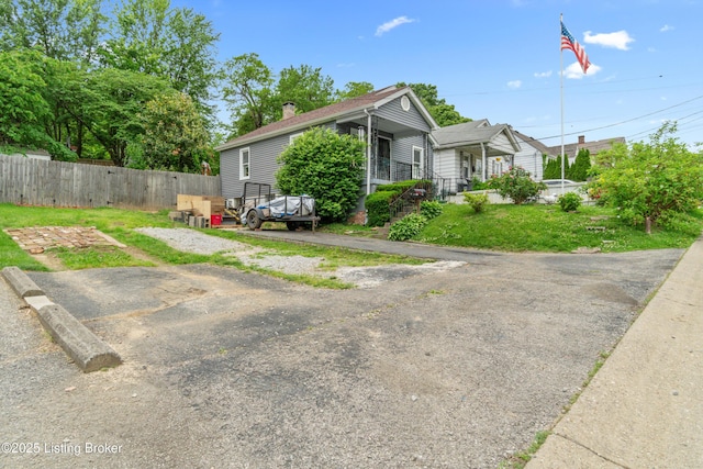 1412 Haskin Ave, Louisville, KY 40215 - view of front of house with fence and a chimney