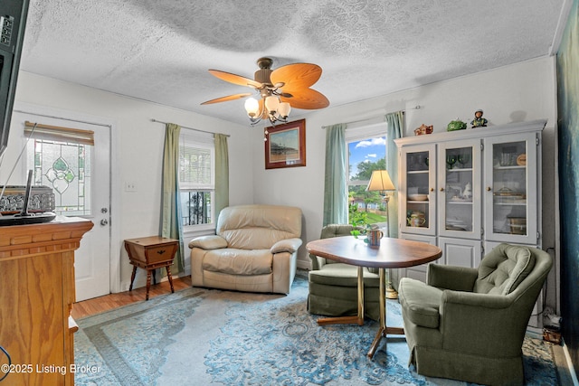 1412 Haskin Ave, Louisville, KY 40215 - sitting room with wood finished floors, plenty of natural light, a textured ceiling, and a ceiling fan