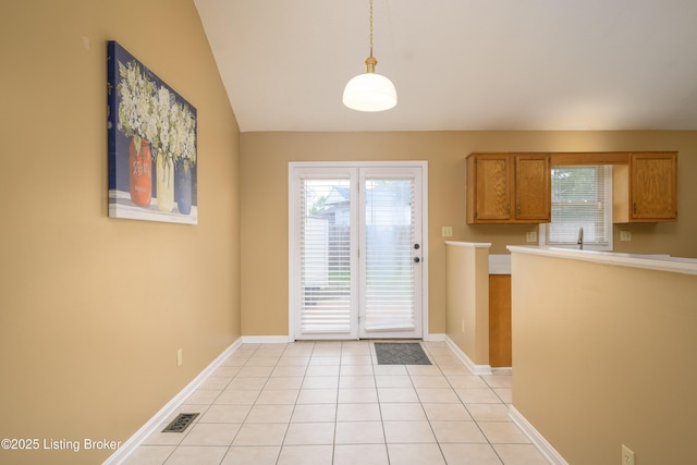 9901 Park Lake Cir, Louisville, KY 40229 - kitchen featuring healthy amount of natural light, light countertops, light tile patterned floors, lofted ceiling, and hanging light fixtures
