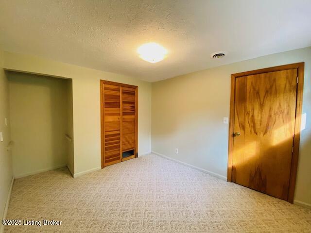 606 Nally Ct, Bardstown, KY 40004 - unfurnished bedroom with a closet, carpet floors, a textured ceiling, and baseboards