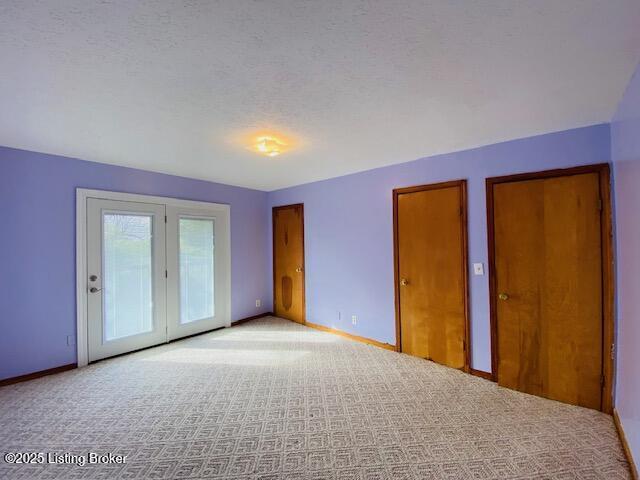 606 Nally Ct, Bardstown, KY 40004 - unfurnished bedroom with carpet flooring, baseboards, and two closets
