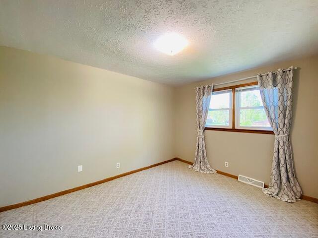 606 Nally Ct, Bardstown, KY 40004 - empty room with a textured ceiling, carpet flooring, and baseboards