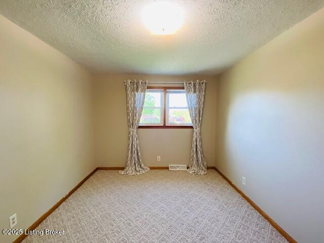 606 Nally Ct, Bardstown, KY 40004 - empty room with a textured ceiling, baseboards, and light colored carpet