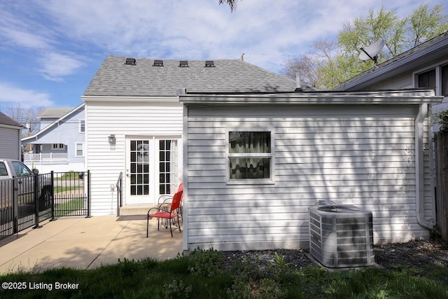1517 Hoertz Ave, Louisville, KY 40217 - back of house featuring central air condition unit, fence, a patio, and a shingled roof