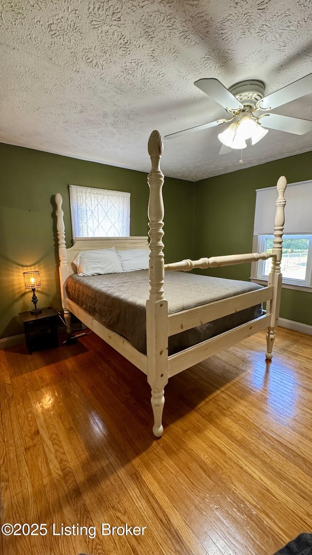 1239 Schiller Ave, Louisville, KY 40204 - bedroom with wood finished floors, a textured ceiling, and a ceiling fan
