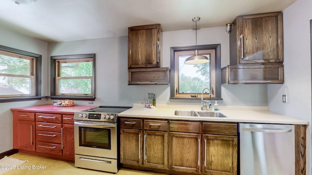 5303 Park Rd, Louisville, KY 40214 - kitchen with appliances with stainless steel finishes, a sink, decorative light fixtures, and light countertops