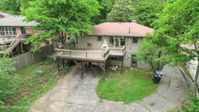 5303 Park Rd, Louisville, KY 40214 - rear view of house featuring a wooden deck, fence, driveway, a chimney, and a carport