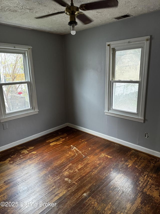 1614 Washington Blvd, Lyndon, KY 40242 - empty room with dark wood-style floors, baseboards, a ceiling fan, and a textured ceiling