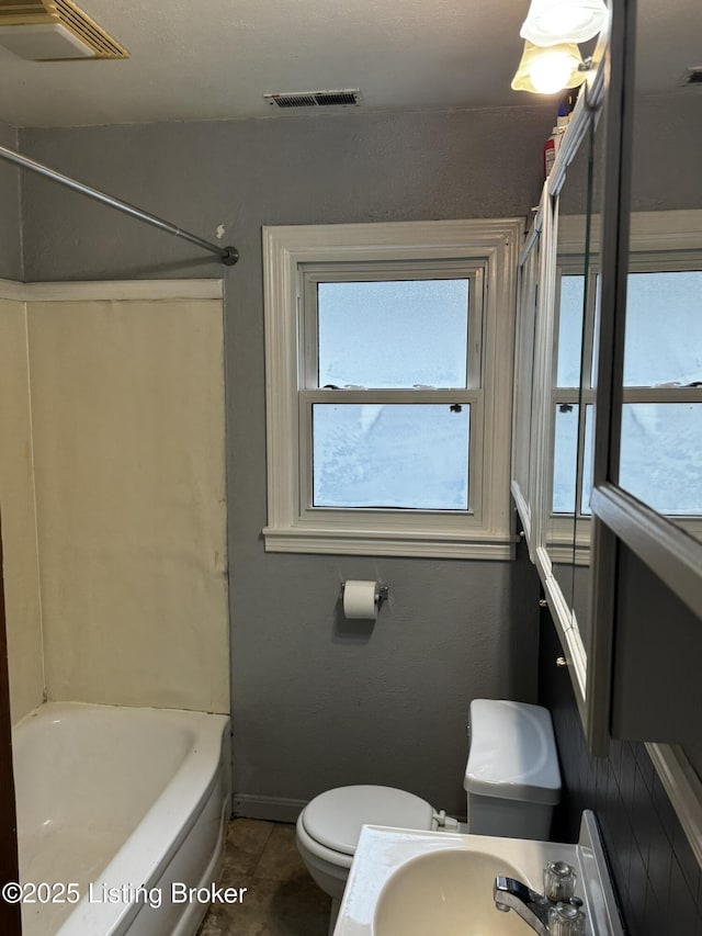 1614 Washington Blvd, Lyndon, KY 40242 - full bathroom featuring toilet, baseboards, a sink, tile patterned flooring, and  shower combination