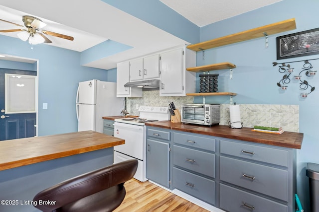 kitchen with butcher block counters, white appliances, decorative backsplash, and a ceiling fan