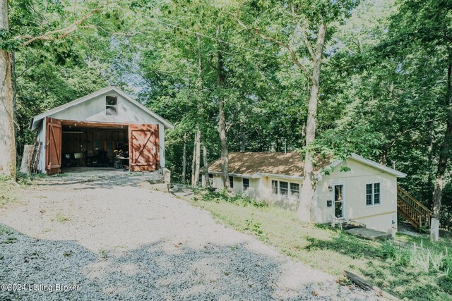 3085 Centerview Rough River Ln, Hudson, KY 40145 - exterior space with a detached garage, an outbuilding, a pole building, stairway, and stucco siding