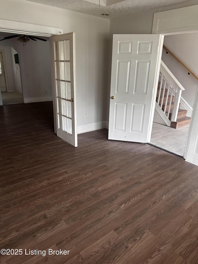 2325 Bolling Ave, Louisville, KY 40210 - spare room featuring dark wood-type flooring, baseboards, stairs, a ceiling fan, and arched walkways