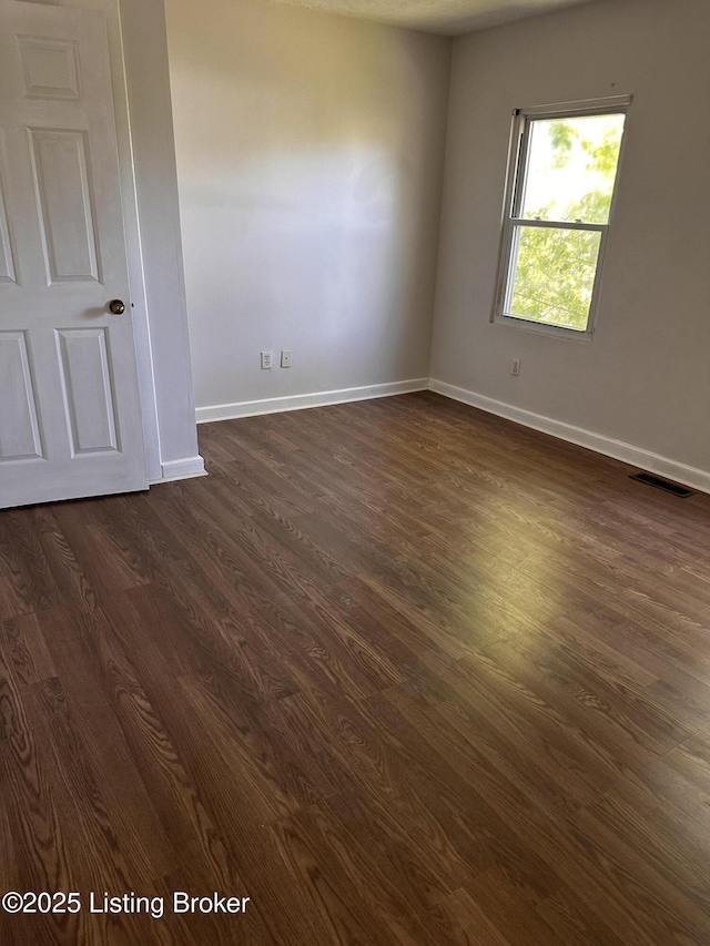 2325 Bolling Ave, Louisville, KY 40210 - empty room with dark wood-style floors and baseboards