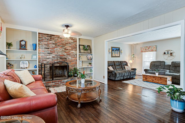 3904 Bayonne Ct, Jeffersontown, KY 40299 - living room with a textured ceiling, wood finished floors, built in shelves, a fireplace, and ceiling fan