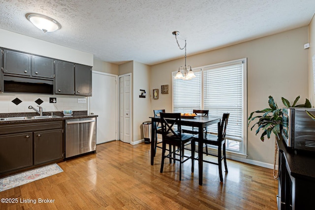 3904 Bayonne Ct, Jeffersontown, KY 40299 - kitchen featuring dishwasher, a sink, dark countertops, a chandelier, and light wood-type flooring