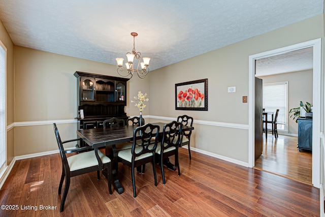 3904 Bayonne Ct, Jeffersontown, KY 40299 - dining space with wood finished floors, a chandelier, a textured ceiling, and baseboards