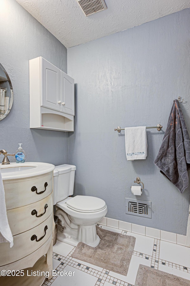 3904 Bayonne Ct, Jeffersontown, KY 40299 - bathroom featuring a textured ceiling, toilet, and vanity