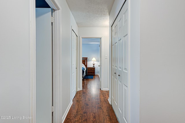 3904 Bayonne Ct, Jeffersontown, KY 40299 - hallway with dark wood-style floors, a textured ceiling, and baseboards