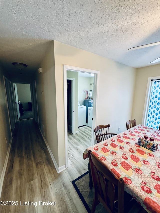 136 Anna Dr, Rineyville, KY 40162 - dining space with washer and clothes dryer, wood finished floors, baseboards, and a textured ceiling