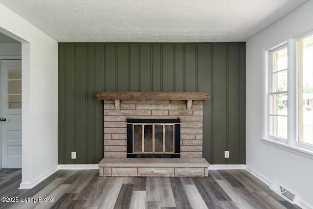 6100 Jessamine Ln, Louisville, KY 40258 - detailed view of baseboards, wood finished floors, a fireplace, and a textured ceiling